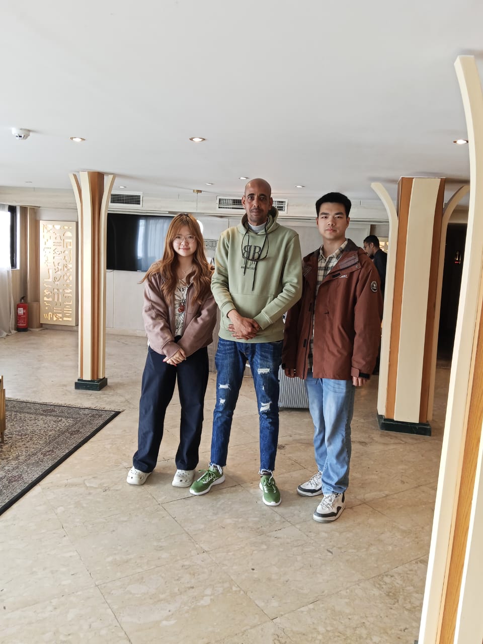 Three guests in the cruise ship's bright lounge