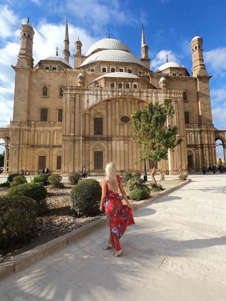 The Citadel of Cairo in daylight, a visitor walking its courtyard